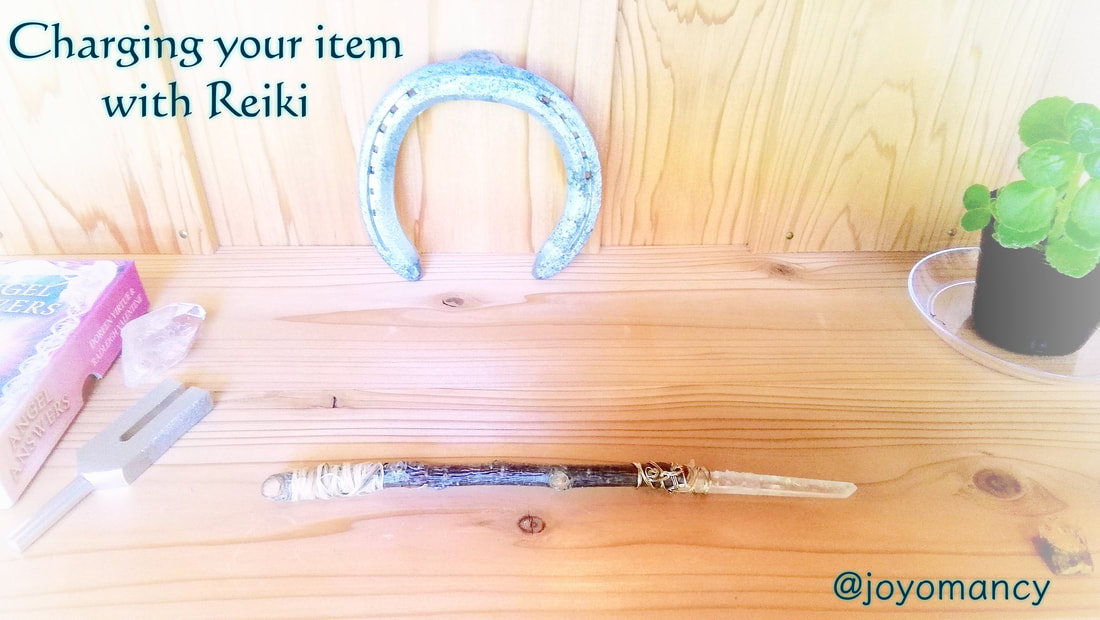 crystal wand and other spiritual tools charged with reiki energy by a reiki master
