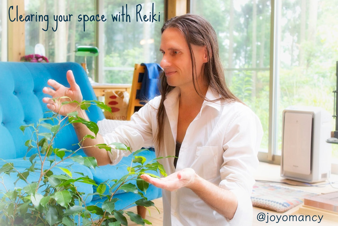 reiki healer clearing a personal space with reiki energy